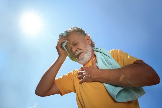 person holding towel to head