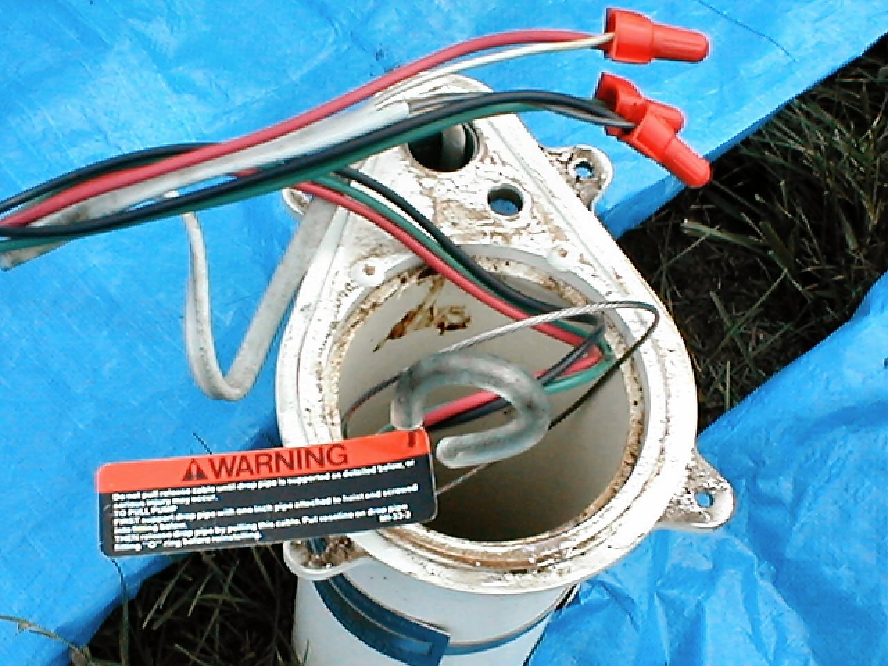 Wires with connector caps showing outside well casing