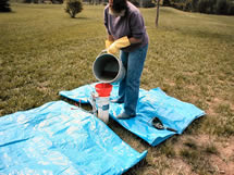 Person pouring bleach solution through funnel into well casing