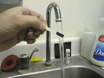 test paper being rinsed with tap water
