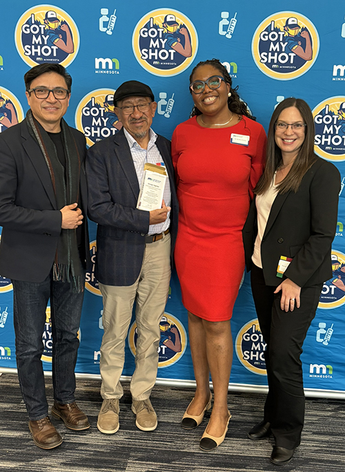 Division Director Odi Akosionu-DeSouza poses with three CCC representatives