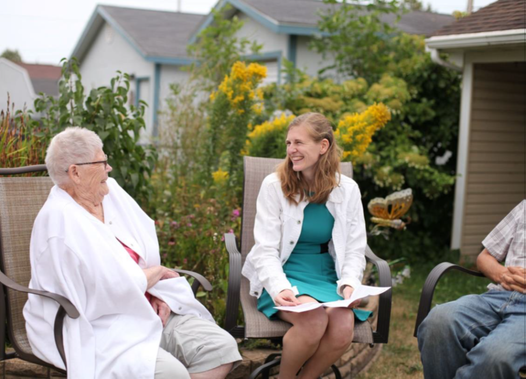 Photo of changemakers visiting with community members.