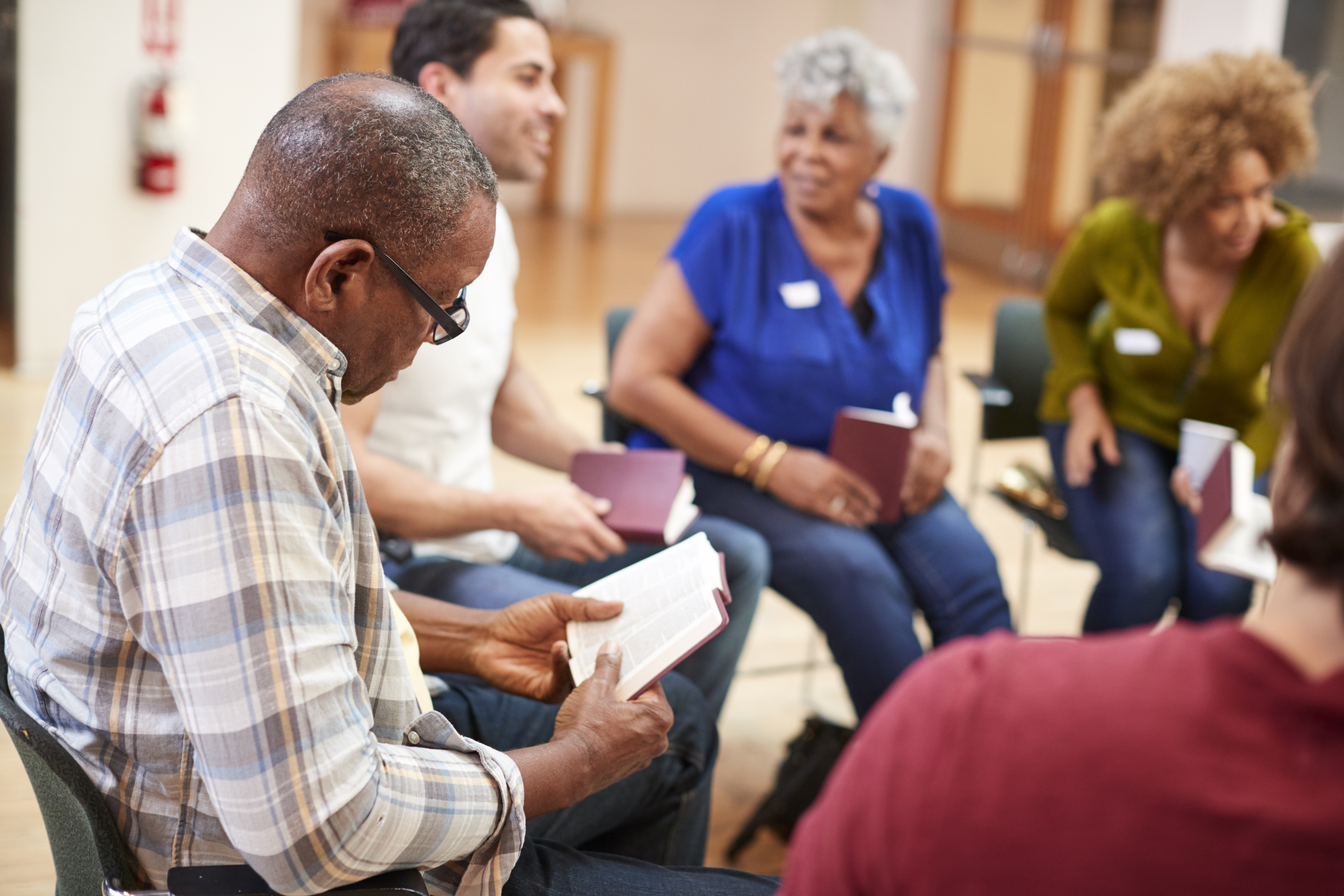 group of people sitting in a circle chatting