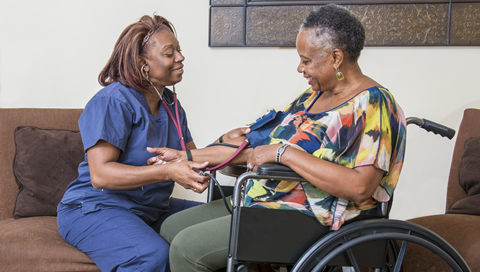 Nurse taking patient's blood pressure