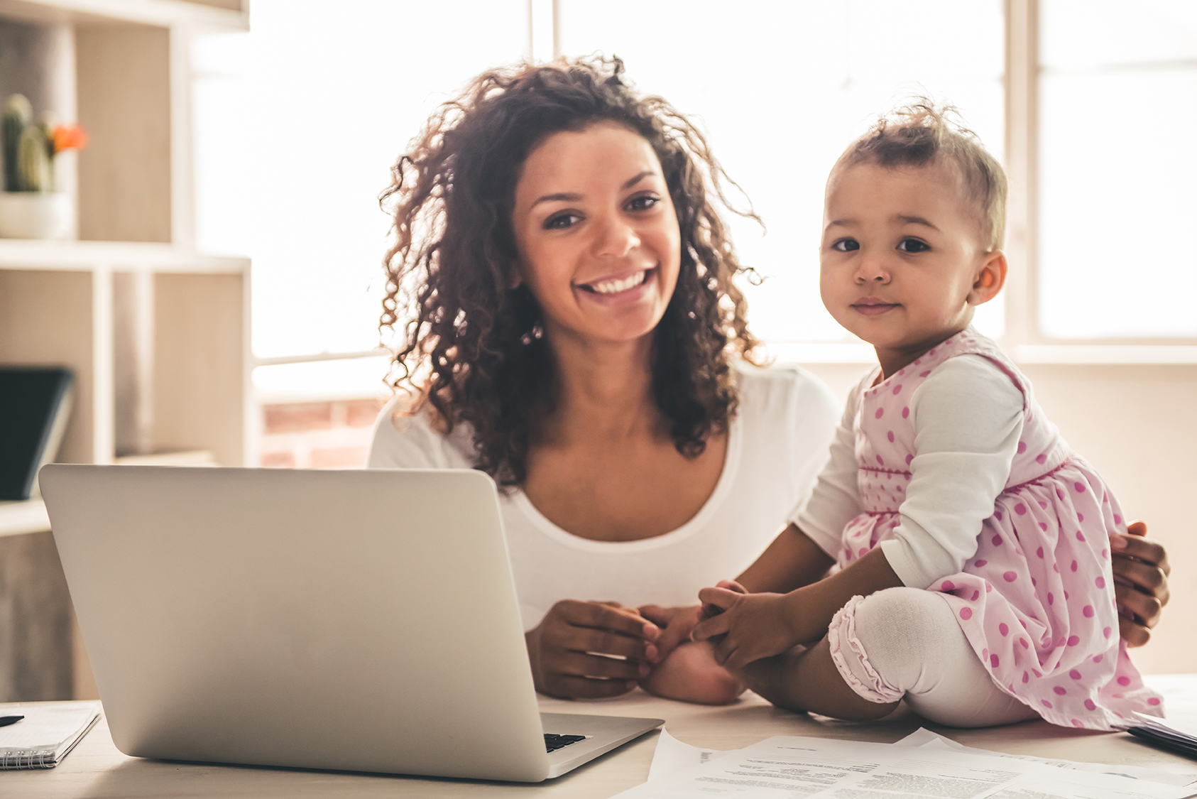 Mom and baby with laptop.