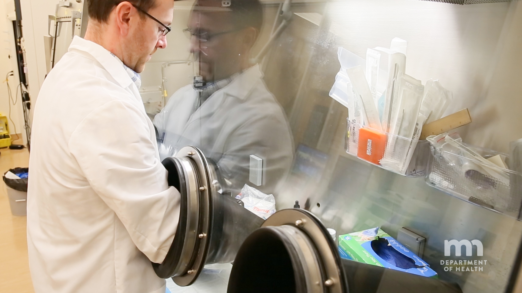 scientist using biosafety cabinet